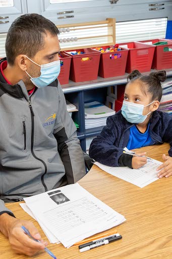 Teacher helping a student in class