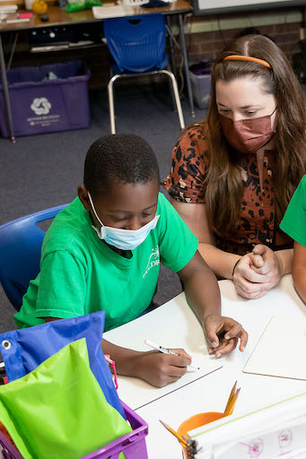 Teacher helping a student in class